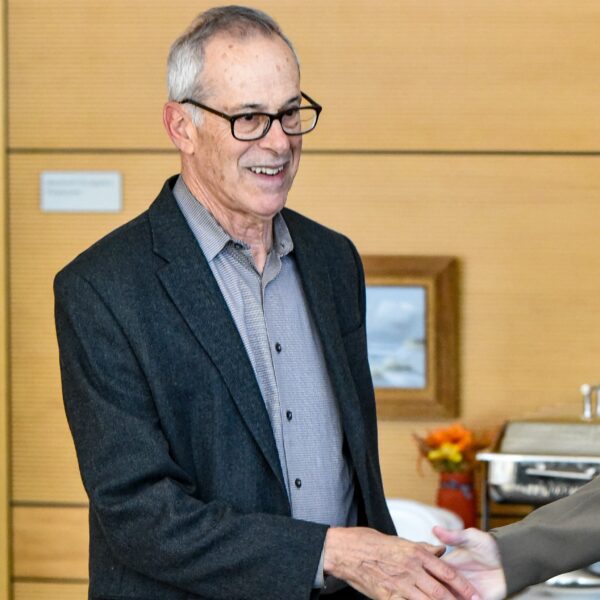 David Walt shaking hands with someone out of frame.